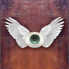 The American Renaissance Tarot by Schiffer Publishing, Ltd. features a central eyeball with white wings on textured brown leather, bordered with brass rivets—evoking Major Arcana symbolism inspired by American literature.