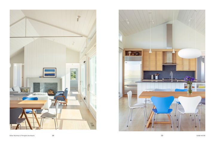 Split view of stylish living and dining spaces with white walls, wooden tables, blue and white chairs, large windows, fireplace, and pendant lights—Second Home by Schiffer Publishing, Ltd. showcases a sanctuary for rejuvenation.