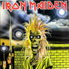 A cartoonish zombie figure with spiky yellow hair and glowing eyes stands by a brick wall under a stormy sky, channeling heavy metal album art. "The Art of Metal" by Schiffer Publishing, Ltd., appears in bold red letters at the top.