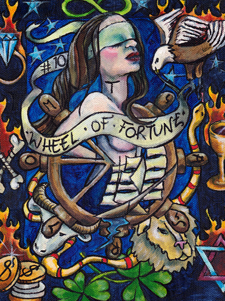 A vibrant artwork from Bonefire Tarot by Schiffer Publishing, Ltd. shows a blindfolded woman with a wheel, animals, snake, coins, cup, clover, and flames. A ribbon states “WHEEL OF FORTUNE” on a striking blue background.