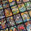 The Bonefire Tarot by Schiffer Publishing, Ltd. showcases hand-painted cards with vibrant illustrations of figures, symbols, and mystical elements, all arranged in a slightly overlapping display.