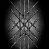 Ten textured wooden sticks are arranged symmetrically in crisscrossed layers against a dark gradient, evoking woven geometry reminiscent of the Nightfall Tarot by Schiffer Publishing, Ltd.