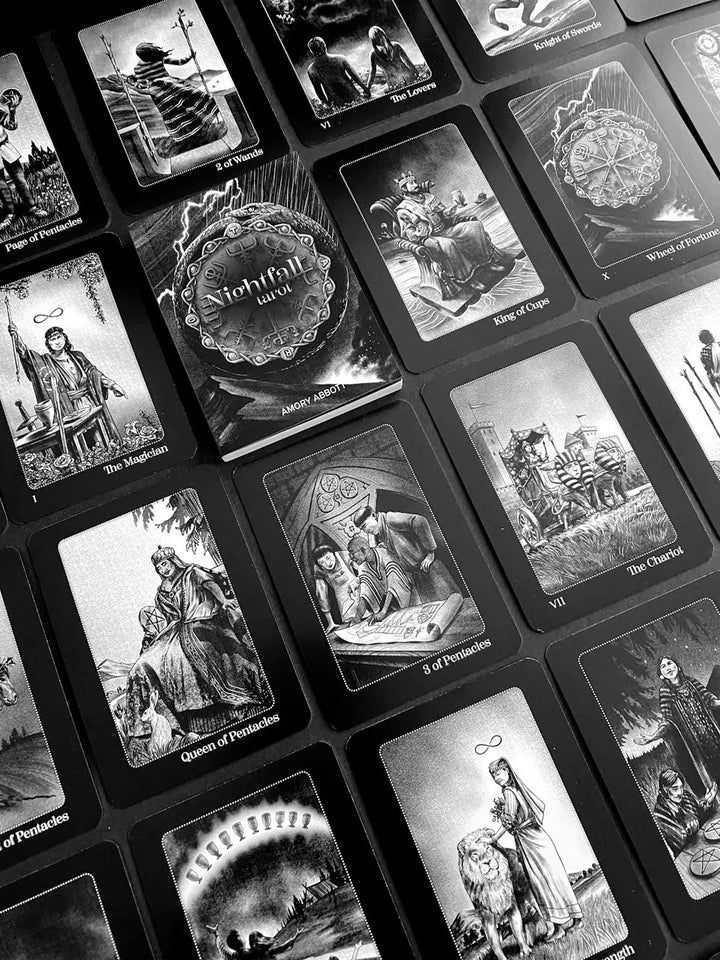 A black and white photo shows Schiffer Publishing, Ltd.'s Nightfall Tarot cards in a grid pattern, displaying detailed illustrations and labels like The Magician, Wheel of Fortune, and Queen of Pentacles.