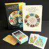The Time Changer's Tarot by Schiffer Publishing, Ltd. is displayed with its modern tarot deck partially spread, two individual cards, and a wooden square on a black surface.