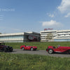 Three classic Alfa Romeo cars from Schiffer Publishing, Ltd. are parked by the modern Alfa Romeo factory museum under a blue sky, with grass and flowers in front, showcasing the rich history and Italian legacy of Alfa Romeo.