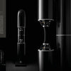 Three copies of "The Art of Luxury Design" by Schiffer Publishing, Ltd. are displayed against a dark background, their elegant covers reflecting the sophisticated aesthetics of high-end architecture and luxury living.