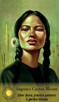 A woman with long dark hair in two braids stands before desert cacti, wearing a white flower earring and gazing ahead. Text below reads: Saguaro Cactus Bloom from The Flowerwise Oracle by Schiffer Publishing, Ltd.—a guide to patience.