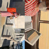 A person in a red-and-white striped dress and mask stands outside with orange luggage, perhaps on their way to a Craft Schools workshop from Schiffer Publishing, Ltd. In another view, they work on a laptop and tablet by a window with a field outside, honing their handmade skills through online craft education offered by Schiffer Publishing’s Craft Schools.
