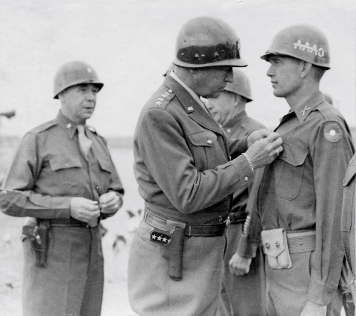 A U.S. Army general pins a medal on a soldier of the 39th Infantry Regiment during a WWII ceremony in the field—scene from "Dying Hard" by Schiffer Publishing, Ltd.