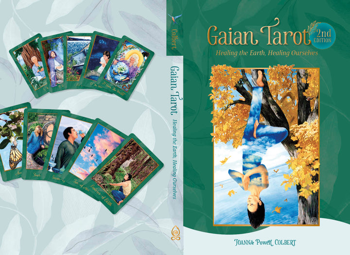 Book cover for Gaian Tarot by Schiffer Publishing, Ltd., showing an earth-centered spirituality tarot card with a person hanging upside down and eight vibrant, multicultural Tarot cards fanned out.