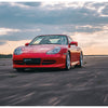 A Porsche RS from Schiffer Publishing, Ltd. speeds down an empty, wide open road at sunset, dramatic clouds above and blurred pavement below emphasize its motion and power.