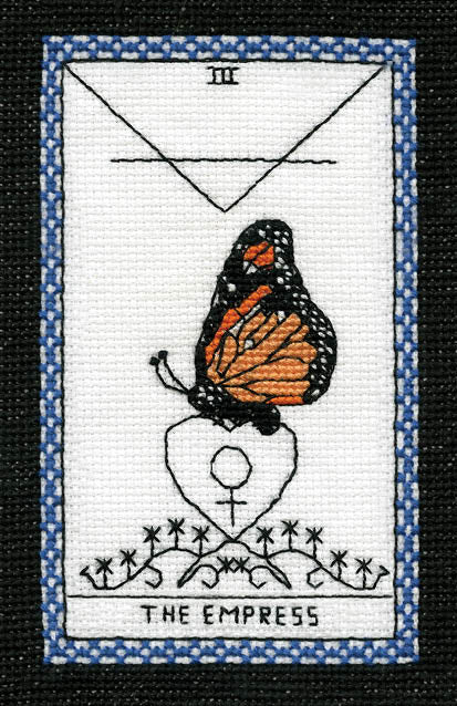 The Butterfly Wisdom Tarot by Schiffer Publishing, Ltd. features The Empress card: a monarch butterfly on a Venus symbol, decorative patterns below, a blue patterned border, and the number III at the top, reflecting transformative healing.