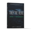 The dark cover of They’re Here by Schiffer Publishing, Ltd. features a glowing circular UFO landing site, a bold green accent, and a testimonial quote at the top, capturing intrigue about UFOs and their occupants.