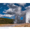 Yellowstone National Park by Schiffer Publishing, Ltd. captures Old Faithful erupting with a soaring steam column under a blue, cloud-dotted sky, surrounded by grasslands and forest—highlighting one of the park’s most iconic geothermal wonders.