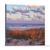 Outer Banks by Schiffer Publishing, Ltd. features a cover image of a beach with sea grass, sand dunes, and the ocean under a partly cloudy sky near Cape Hatteras in North Carolina's scenic Outer Banks.