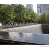 Visitors view the waterfall and inscribed names at the 9/11 Memorial, a prominent landmark in New York City.