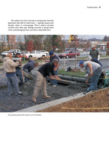 Construction workers pave a roadway with pervious concrete, as described in "Paving with Pervious Concrete" by Schiffer Publishing, Ltd., with buildings, vehicles, and trees visible in the background.