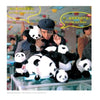 A man in a cap examines plush pandas with a magnifying glass, echoing contemporary Chinese art themes. Speech bubbles read, "Are they clones of me?" and "No, they are fakes!" Colorful toys fill the background. From "Chinese Artists" by Schiffer Publishing, Ltd.