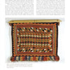 The Native American Horse Gear by Schiffer Publishing, Ltd. is a rectangular saddle blanket inspired by 19th-century styles, with geometric diamond and triangle patterns in warm orange, red, brown, and beige tones, and fringed along the bottom edge.