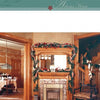Inspired by "Decorating for Christmas at Historic Houses" by Schiffer Publishing, Ltd., this vintage-style living room features festive décor, a garland-draped fireplace, set dining table, and a charming wooden staircase.