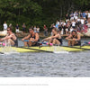 Four rowers in a yellow boat race fiercely as spectators watch from the tree-lined shore—a thrilling scene from *A History of Collegiate Rowing in America* by Schiffer Publishing, Ltd.