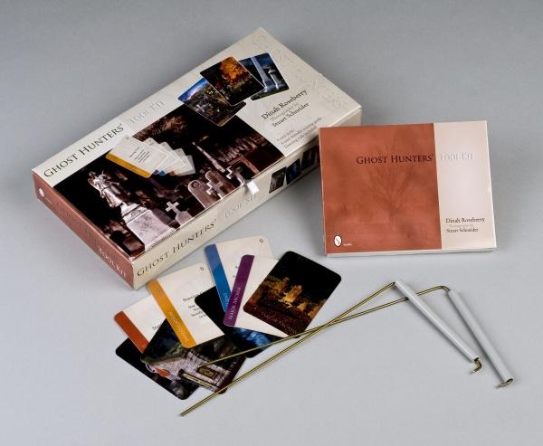 The Ghost Hunters' Tool Kit by Schiffer Publishing, Ltd. includes the box, instructions, metal dowsing rods and stakes for ghost investigations, plus laminated cards featuring photos of different locations.