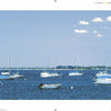Sailboats and small motorboats rest on calm blue water beneath a clear sky, with distant buildings and trees, captured in classic North Shore Massachusetts style from "North Shore Wide" by Schiffer Publishing, Ltd.