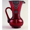 A striking vintage piece from Mauzy's Rare, Unusual, & Unique Depression Glass by Schiffer Publishing: a tall, deep red glass pitcher with ornate handle and silver overlay, beautifully displayed against a plain white background.