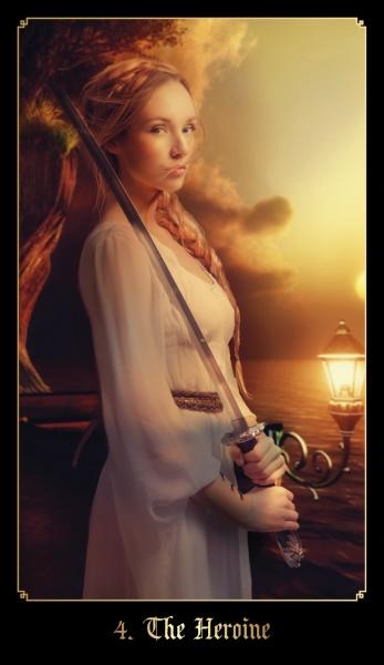 A woman in a flowing dress stands by a tree at sunset, gripping a sword, her determined expression evoking The Chronicles of Destiny Fortune Cards by Schiffer Publishing, Ltd. “4. The Heroine” is inscribed at the bottom of the image.