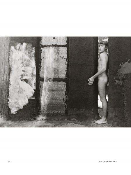 She Shoots Men by Schiffer Publishing, Ltd.: A black and white photo captures an intimate nude male figure in a narrow doorway, framed by textured walls as window light casts dramatic shadows.