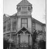 Black and white photo of a tall, ornate Victorian house with a tower and gated entrance—one of South Texas’s haunted places. Text: Texas Ghosts by Schiffer Publishing, Ltd. Includes Galveston 133 and The Gingerbread House.