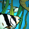 An illustration from "The Fish Tank" by Schiffer Publishing, Ltd. features tropical fish swimming among green aquatic plants with a blue background and a large yellowish rock or coral on the right side.