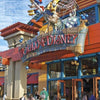 The entrance of the Florida Theme Parks store, by Schiffer Publishing, Ltd., is adorned with large, colorful Disney character statues above the sign, as visitors enter and walk in front.
