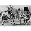 In "Pueblo Dancing" by Schiffer Publishing, Ltd., three Indigenous men in traditional Pueblo attire perform a ceremonial dance outdoors—one in a buffalo headdress, another in deer antlers—honoring Native American heritage as spectators watch.
