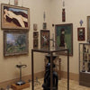A gallery room displays "Birds in the Barnes Foundation" from Schiffer Publishing, Ltd. Paintings, sculptures, and tribal art fill the space, with GALLERY 21 text in the lower left corner.