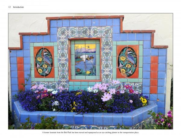 A decorative fountain by Catalina Island Pottery and Tile (Schiffer Publishing, Ltd.) showcases vibrant blue, red, and patterned floral and landscape tiles, repurposed as a planter blooming with colorful flowers.