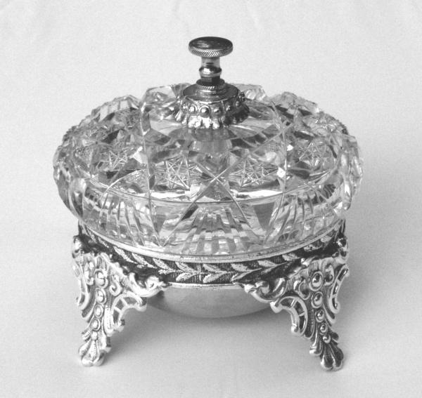 The book "American Glass Bells" by Schiffer Publishing, Ltd. is perfect for glass enthusiasts and collectors, offering detailed insights and images of decorative glass bells, ideal as a display piece on any plain surface.