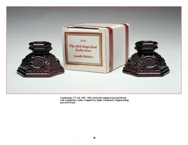 Two ornate, dark red Avon's 1876 Cape Cod Collection candle holders by Schiffer Publishing, Ltd. are displayed with their box, featuring intricate vintage designs—an excellent addition for collectors of American glassware.