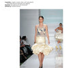 A model showcases a chic cream skirt with a ruffled hem and a sheer, floral top, reflecting trends in "Emerging Fashion Designers" by Schiffer Publishing, Ltd., as audience members line the runway on both sides.