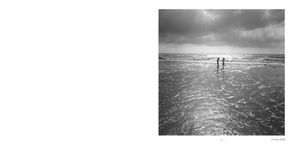 East Coast Atlantic Beaches" by Schiffer Publishing, Ltd.: A serene black-and-white photo shows two people in shallow water, gazing at the ocean under a cloudy, sunlit sky. The elegant scene is beautifully framed with a wide white border.