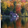 A serene lake reflects autumn trees and homes with large windows. Insets show a rocky lakebed and sunlit forest, capturing Pennsylvania’s peaceful fall beauty in this Schiffer Publishing, Ltd. release for photography enthusiasts.