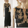 Featured in "Irresistible: The Art of Lingerie, 1920s-1980s" by Schiffer Publishing, Ltd., a mannequin displays a full-length black sleeveless nightgown with beige lace floral and bird embroidery on the bodice, shown in full and close-up views.