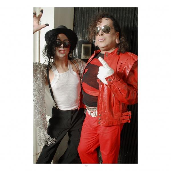 Two people in vibrant costumes and theatrical makeup pose together, embodying the playful spirit found in "Getting into Face" by Schiffer Publishing, Ltd.—a celebration of performance artists' creativity.