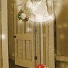 An ethereal woman labeled Intuition floats above a wreath-topped door, with gifts and holly below. "2 ~ High Priestess" appears in festive red—part of A Christmas Tarot, a Majors-only deck from Schiffer Publishing, Ltd.