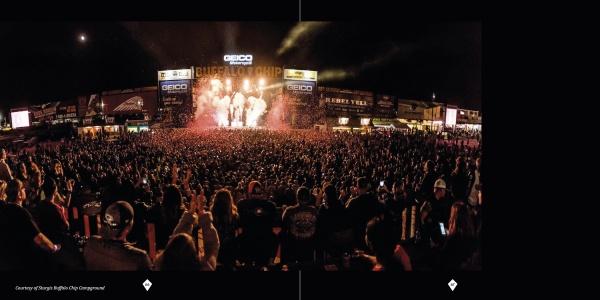 A large crowd, including motorcycle enthusiasts, cheers and enjoys a lively nighttime concert illuminated by bright lights—just like the spirited gatherings featured in "The Meaning of Life According to Bikers" by Schiffer Publishing, Ltd.