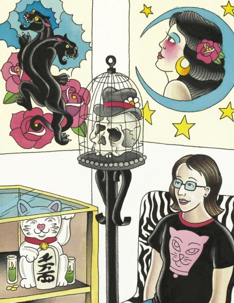 A woman with glasses stands in an art-filled room wearing a black cat shirt. She holds "Mommy's New Tattoo" by Schiffer Publishing, Ltd., surrounded by bold decor: panther tattoo art, a moon and stars portrait, skull sculpture, and lucky cat figure.