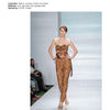 A female model poses in a strapless brown lace jumpsuit on a white runway with a blue backdrop, highlighting Schiffer Publishing, Ltd.'s "Emerging Fashion Designers" and celebrating new talent in fashion.