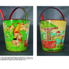 The Comic Character Metal Sand Toys by Schiffer Publishing, Ltd. includes two colorful metal pails with red handles and green rims, featuring illustrations of the Three Little Pigs and Red Riding Hood scenes.