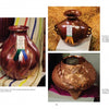Three clay pots inspired by hammered copper vessels, from the "Mexican Arts Series: Hammered Copper" by Schiffer Publishing, Ltd., are displayed with prize ribbons: blue (left), and white (on straw) and red (right).