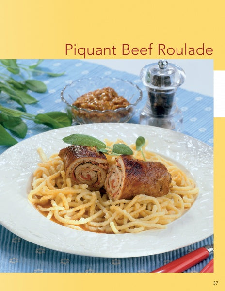 A plate of piquant beef roulade on noodles, garnished with fresh herbs, is featured alongside a small dish of mustard sauce. "Cooking with Mustard" by Schiffer Publishing, Ltd. celebrates unique mustard varieties in flavorful dishes.